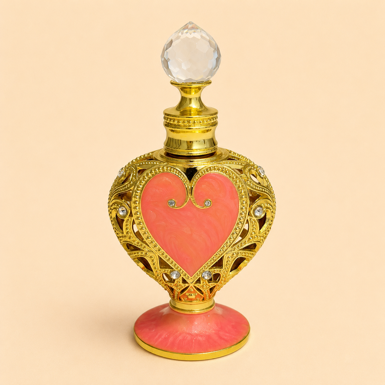Elixir em óleo Perfume da Sereia Rubria em frasco ornamental dourado com coração rosa claro, sobre fundo bege, perfume natural concentrado de luxo.